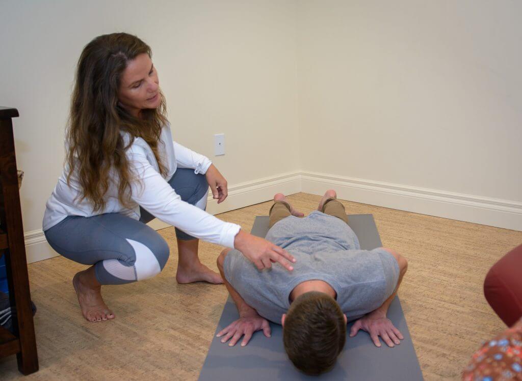 Lala instructing a patient for a yoga move